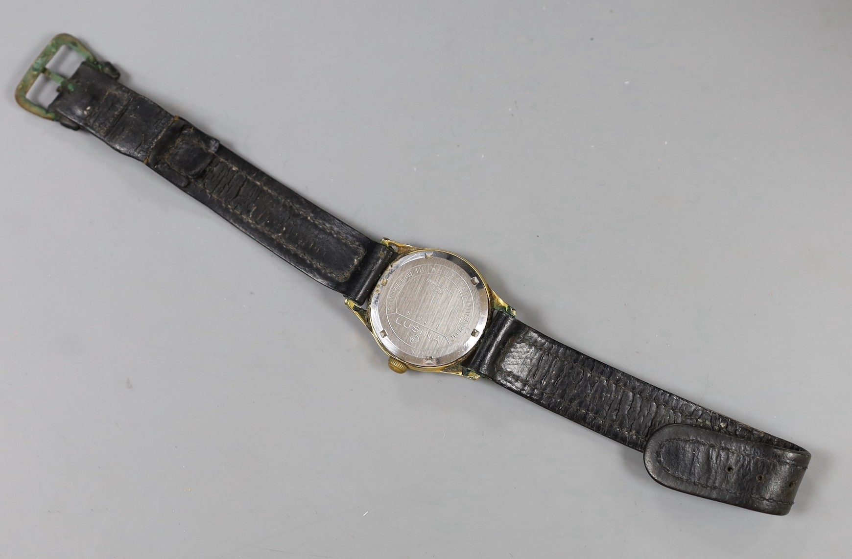 A steel and gold plated boy's size Lusina manual wind wrist watch, on leather strap.